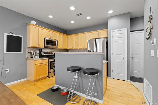 a kitchen with stainless steel appliances a stove a refrigerator and a refrigerator