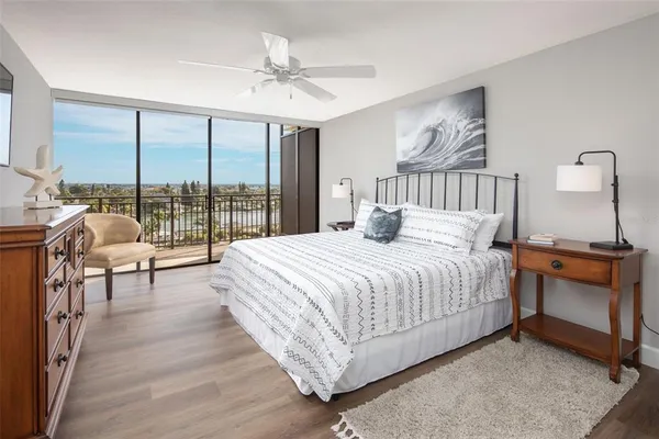 a bedroom with a bed and a large window