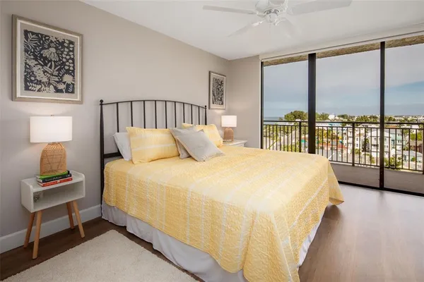 a bedroom with a bed and a lamp next to a window