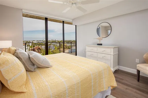 a bedroom with a bed and a large window