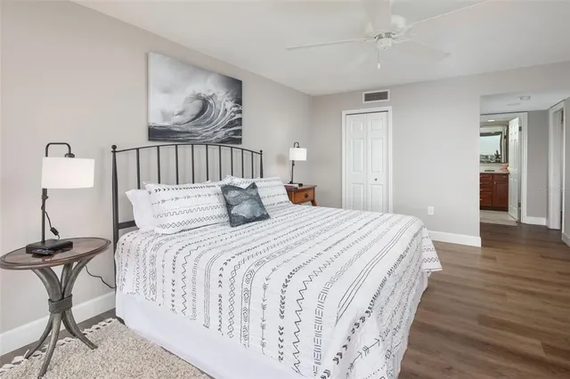 a open kitchen with stainless steel appliances granite countertop a stove and a view of living room with furniture