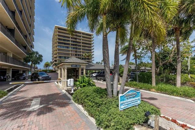 a roof deck with a table and chairs with wooden floor