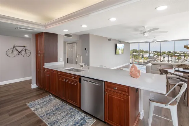 a kitchen with a sink and chairs