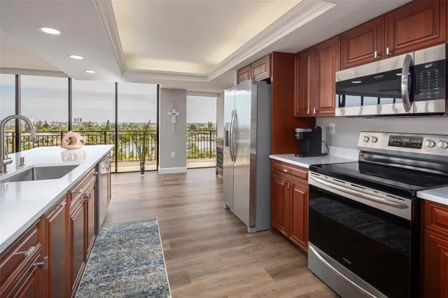 a kitchen with stainless steel appliances granite countertop a stove a sink and a refrigerator