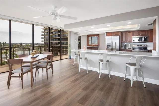 a dining room with furniture window and wooden floor