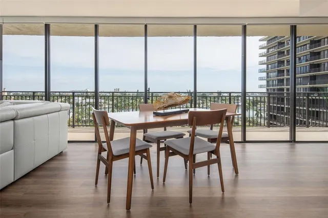 a dining room with furniture window and wooden floor