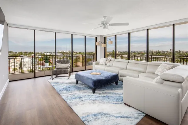 a living room with furniture and large windows