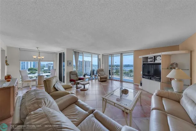 a kitchen with stainless steel appliances granite countertop a refrigerator a stove and a wooden floors