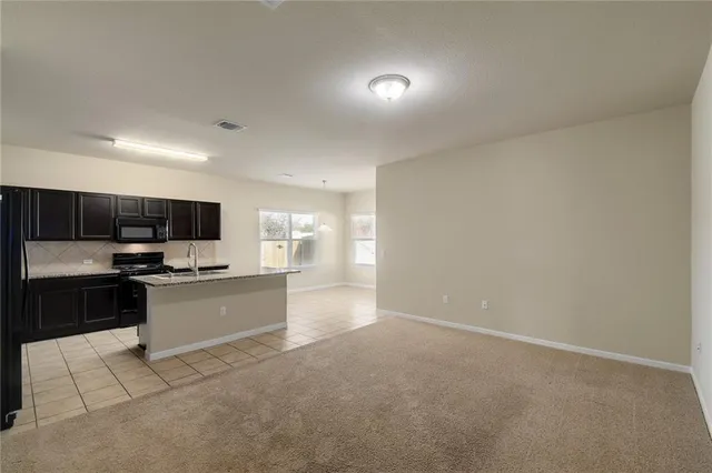 a kitchen with stainless steel appliances a stove a sink and a refrigerator