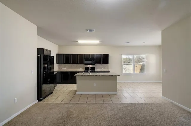 a view of kitchen with microwave cabinets and stove