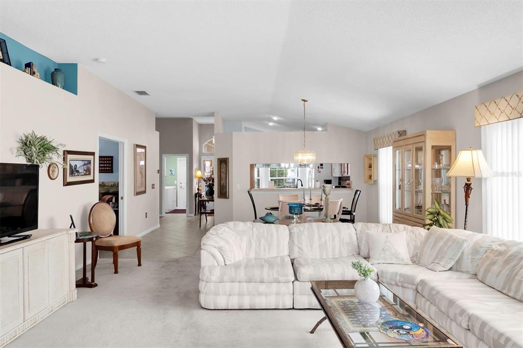 11634 Wheatfield Loop Hudson, FL 34667 - Photo 11 of 38 a living room with furniture and a flat screen tv