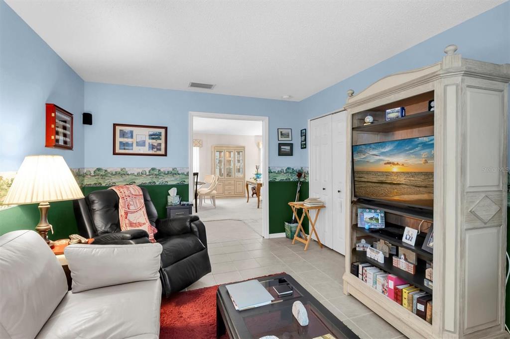 11634 Wheatfield Loop Hudson, FL 34667 - Photo 13 of 38 a living room with furniture and a flat screen tv