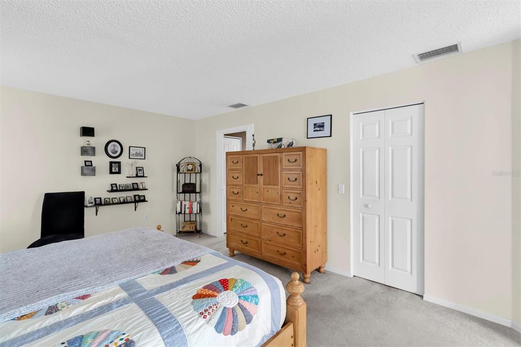 11634 Wheatfield Loop Hudson, FL 34667 - Photo 15 of 38 a view of a bedroom with baby bed and closet