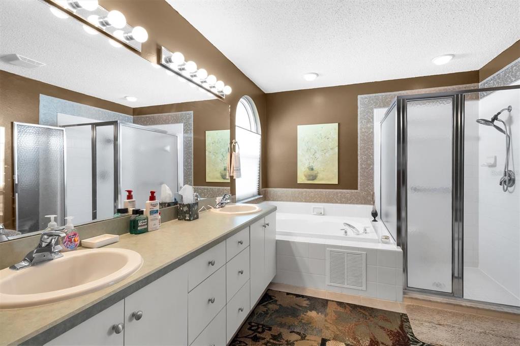 11634 Wheatfield Loop Hudson, FL 34667 - Photo 17 of 38 a spacious bathroom with a double vanity sink mirror and double