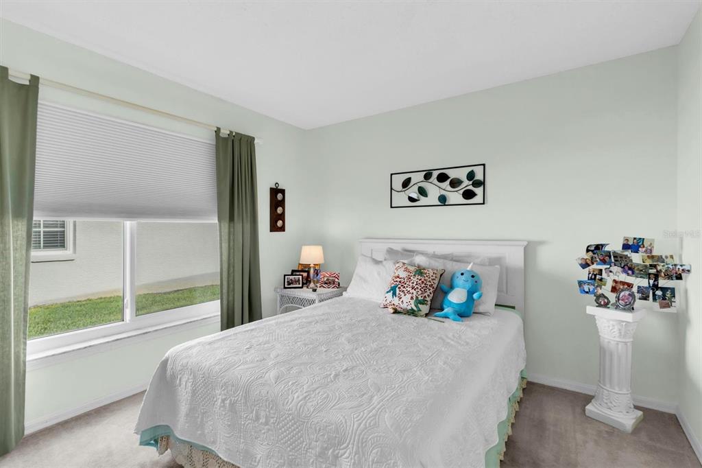 11634 Wheatfield Loop Hudson, FL 34667 - Photo 20 of 38 a bedroom with a bed and a large window