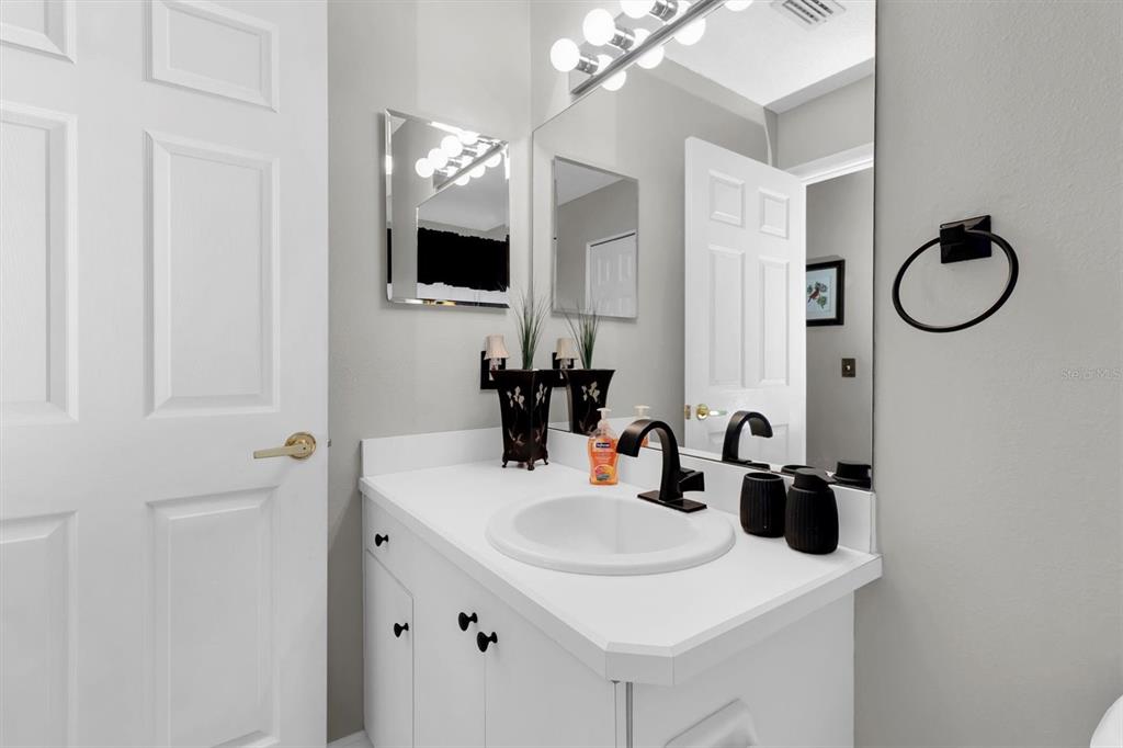 11634 Wheatfield Loop Hudson, FL 34667 - Photo 22 of 38 a bathroom with a sink and a mirror