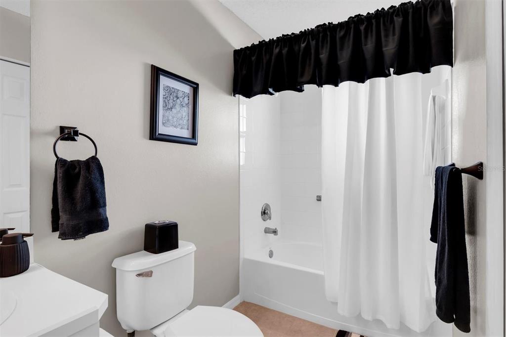 11634 Wheatfield Loop Hudson, FL 34667 - Photo 23 of 38 a bathroom with a sink toilet and shower