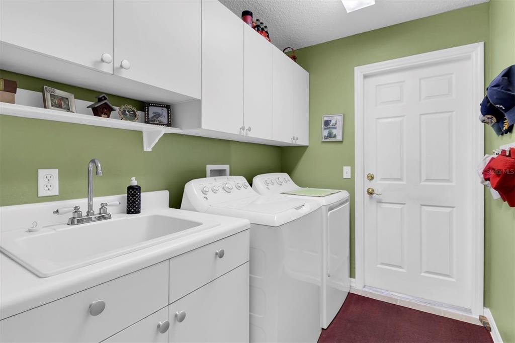 11634 Wheatfield Loop Hudson, FL 34667 - Photo 24 of 38 a utility room with dryer and washer