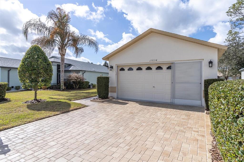 11634 Wheatfield Loop Hudson, FL 34667 - Photo 25 of 38 a view of a white house with a yard