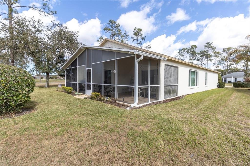 11634 Wheatfield Loop Hudson, FL 34667 - Photo 31 of 38 a view of a house with a yard and garage