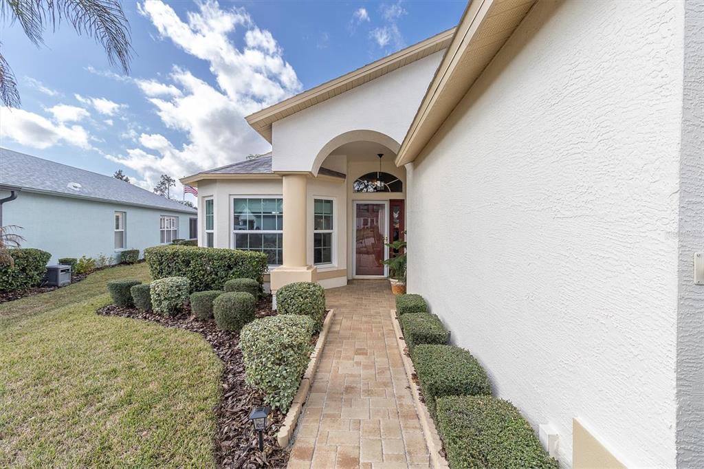 11634 Wheatfield Loop Hudson, FL 34667 - Photo 33 of 38 a view of a front door and a yard