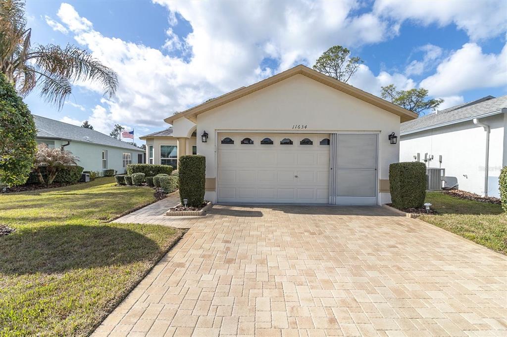 11634 Wheatfield Loop Hudson, FL 34667 - Photo 34 of 38 a view of garage yard and deck