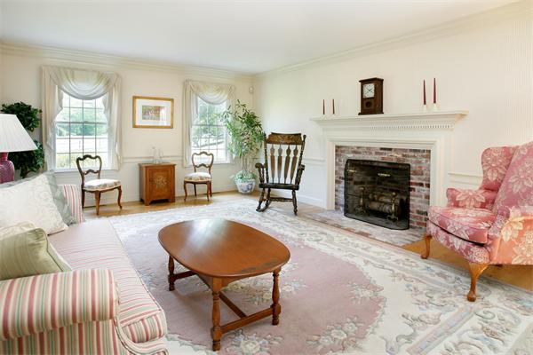 11 Brookmill Road Stow, MA 01775 - Photo 3 of 8 a living room with furniture and a fireplace