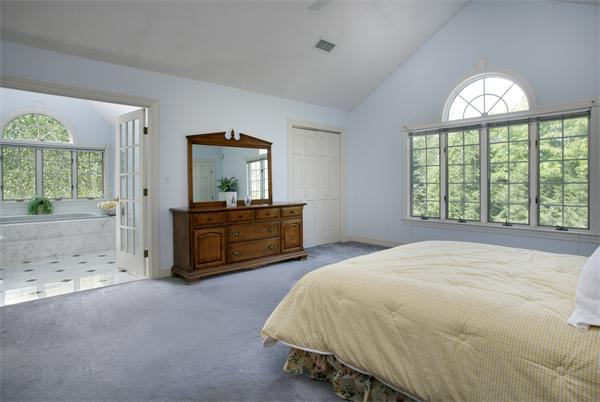 11 Brookmill Road Stow, MA 01775 - Photo 7 of 8 a spacious bedroom with a bed and a painting on the wall