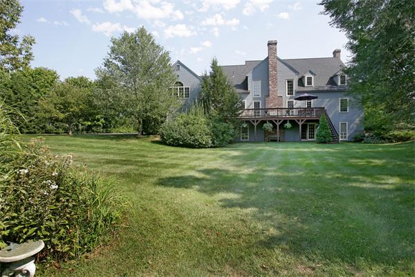 11 Brookmill Road Stow, MA 01775 - Photo 8 of 8 a view of a big house with a big yard and large trees