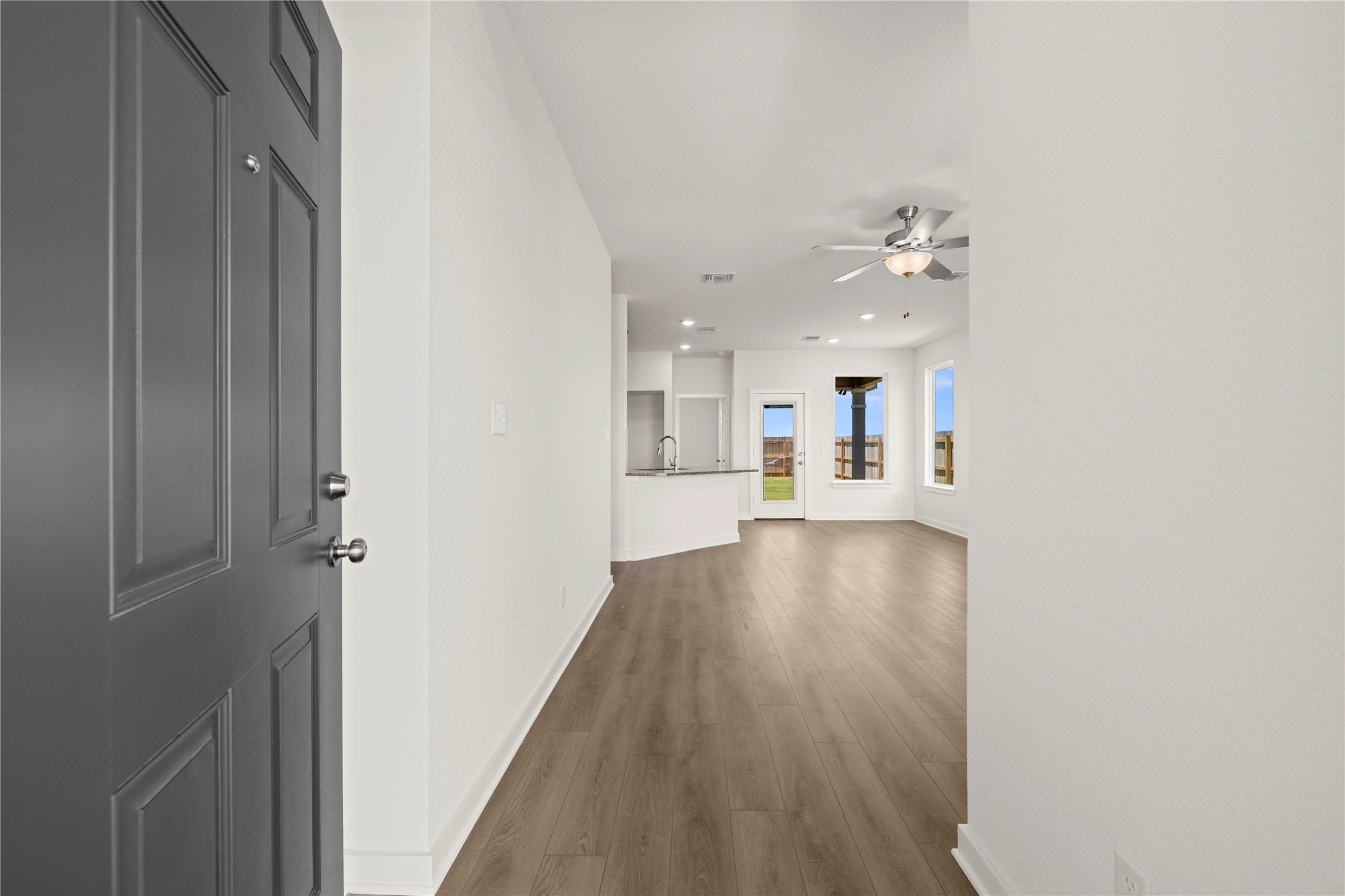 228 Gus Loop Georgetown, TX 78626 - Photo 3 of 19 Upon entering, find an open-concept living space with resilient hardwood flooring and a stylish ceiling fan.