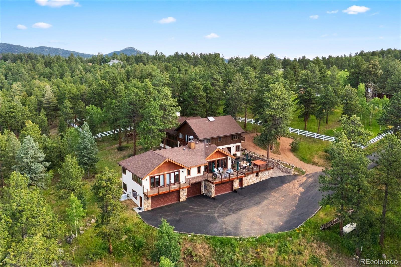 an aerial view of a house with mountain view
