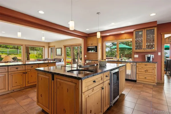 a kitchen with stainless steel appliances granite countertop sink stove top oven and cabinets