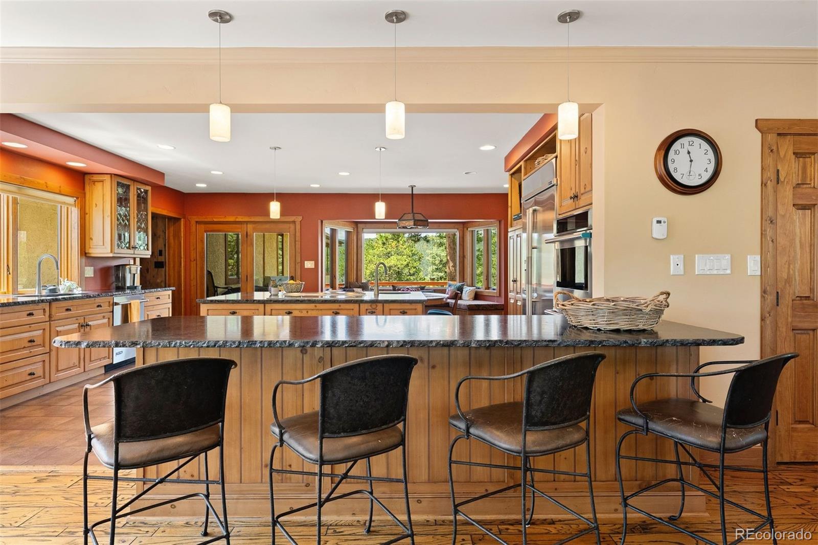 12351 South Ridge Road Conifer, CO 80433 - Photo 16 of 50 a dining hall with stainless steel appliances kitchen island granite countertop a table and chairs