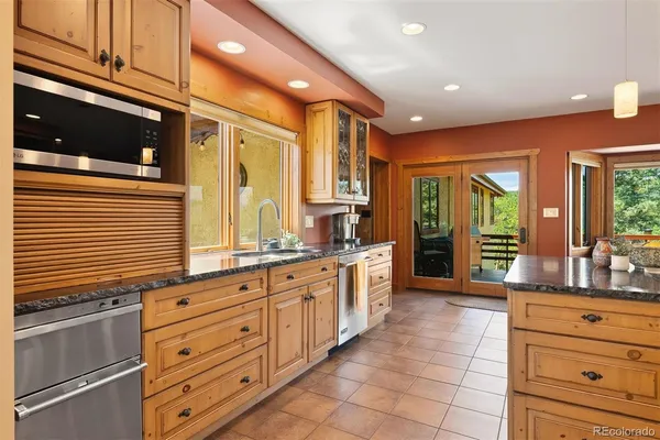 a kitchen with granite countertop a stove and cabinets