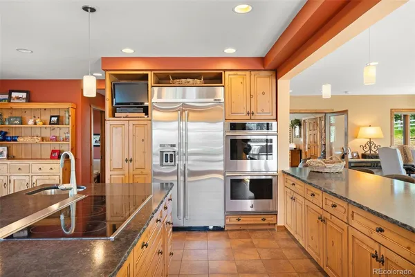 a kitchen with stainless steel appliances a refrigerator and a stove