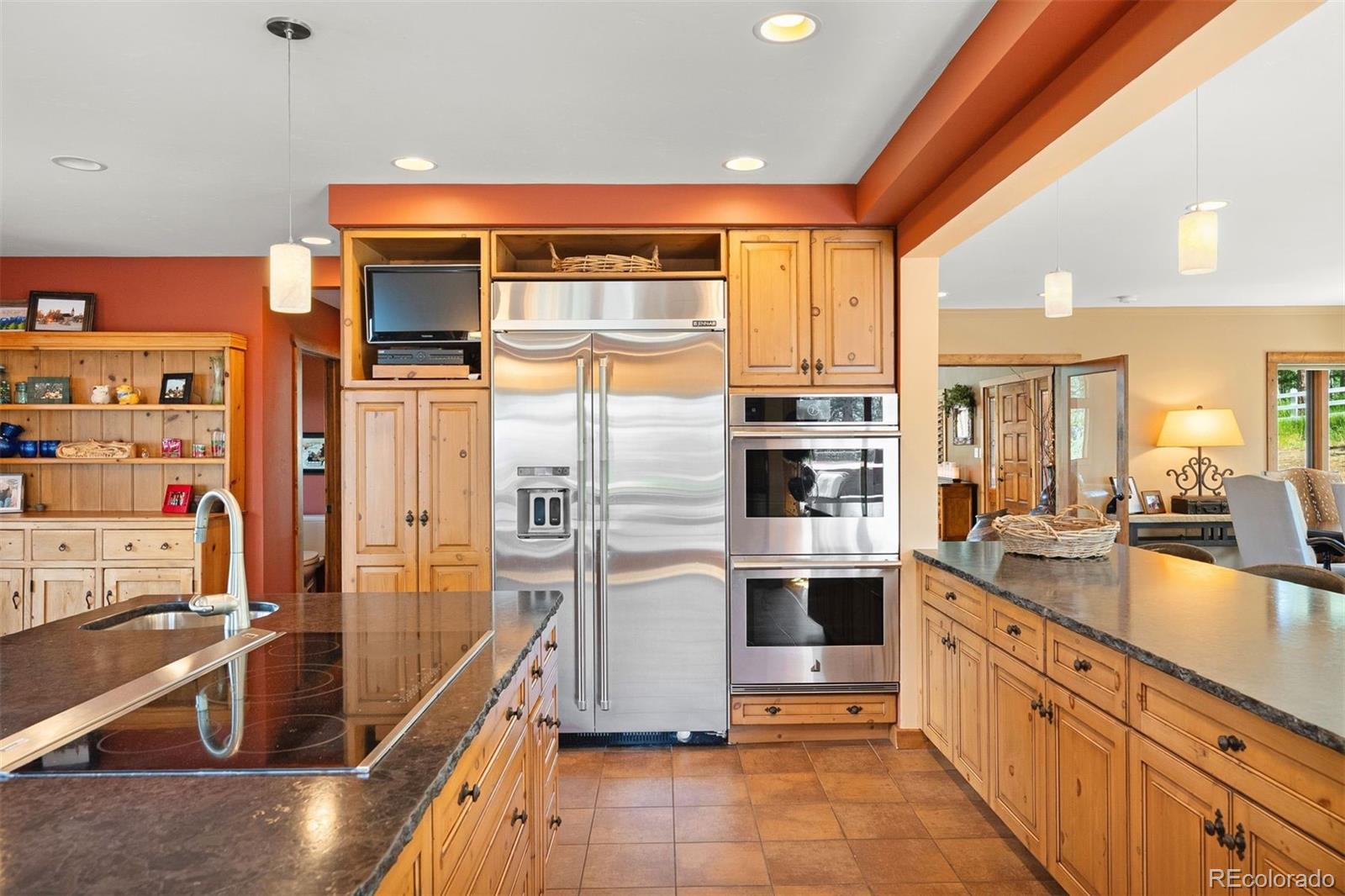 12351 South Ridge Road Conifer, CO 80433 - Photo 19 of 50 a kitchen with stainless steel appliances a refrigerator and a stove