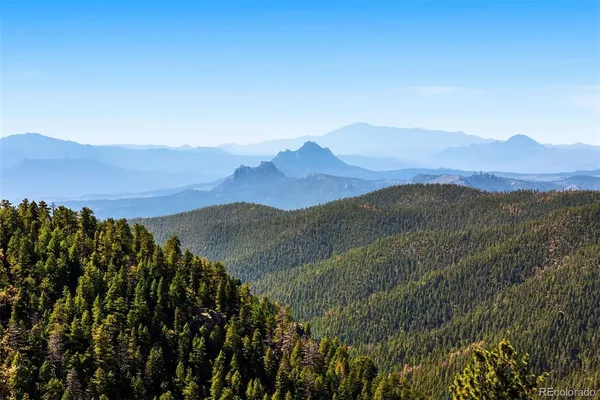 a view of a town with mountains in the background