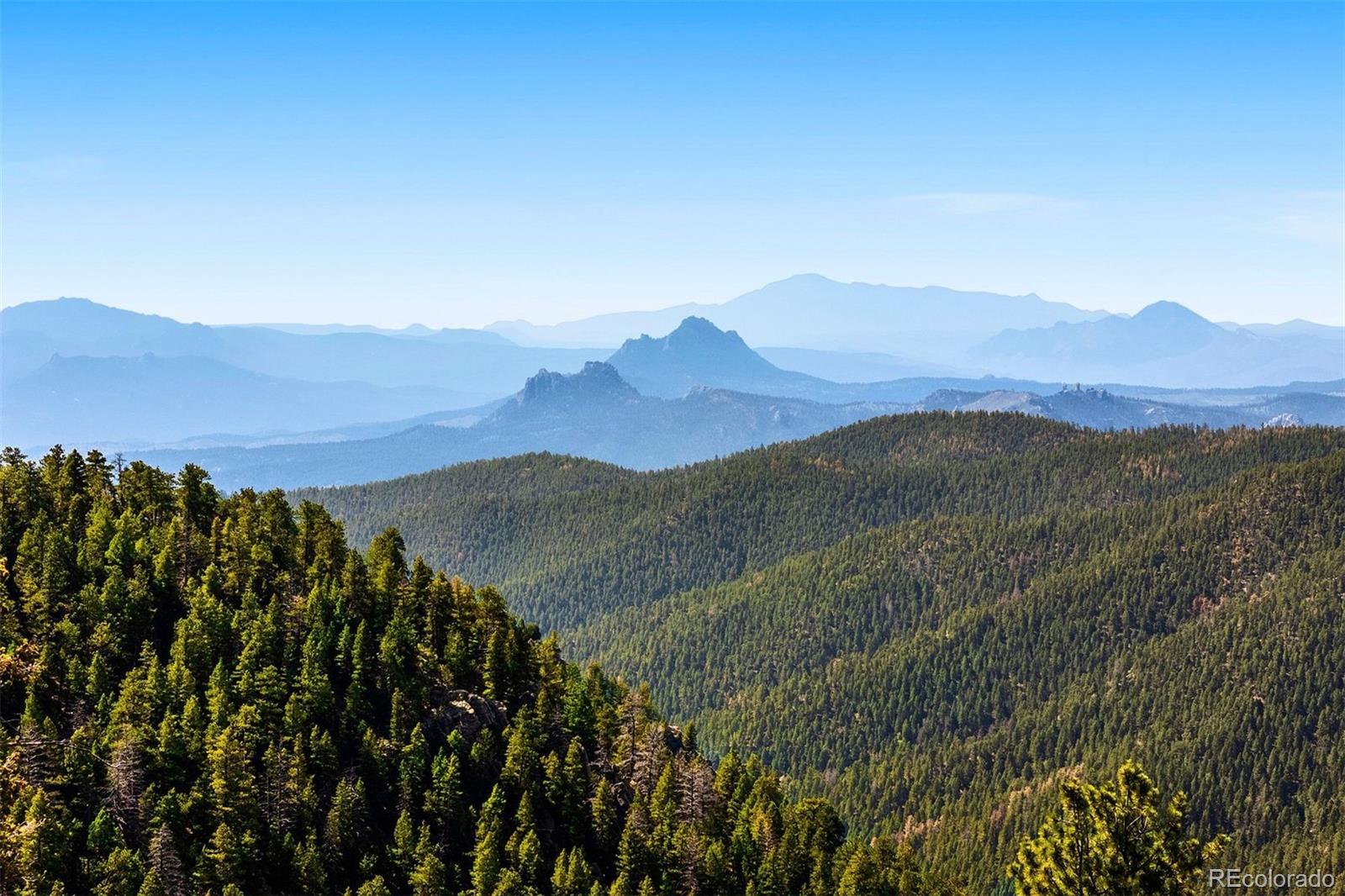 12351 South Ridge Road Conifer, CO 80433 - Photo 2 of 50 a view of a town with mountains in the background