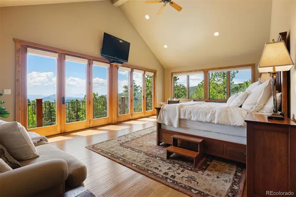 a bedroom with a bed and large window
