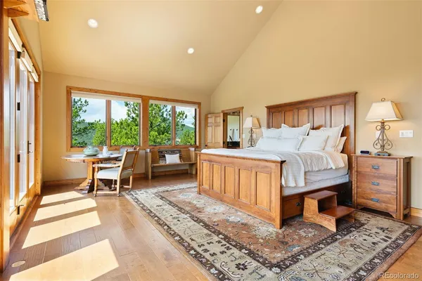 a bedroom with furniture and a large window