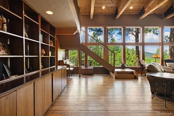 a view of a livingroom with furniture wooden floor and windows