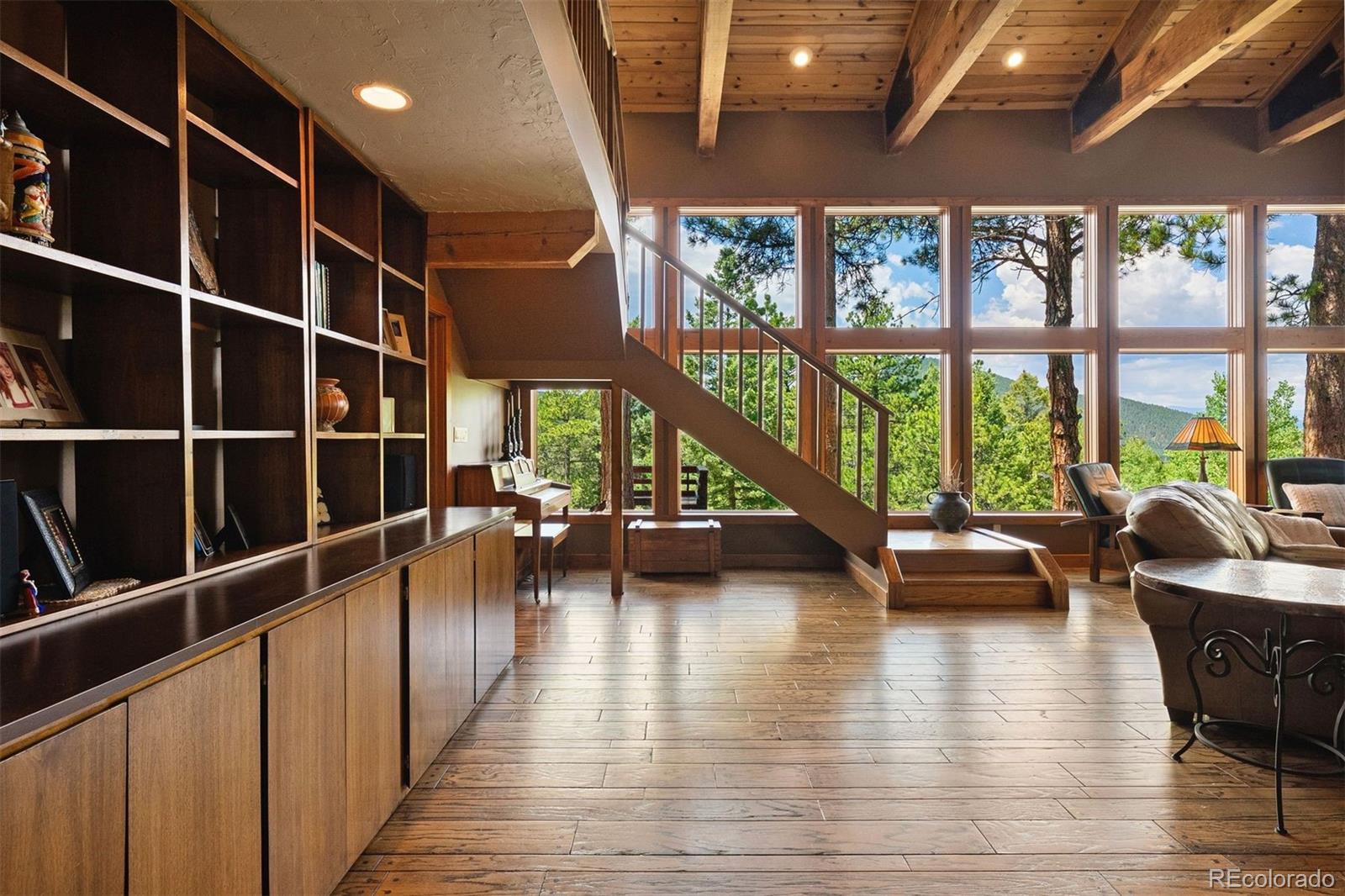 12351 South Ridge Road Conifer, CO 80433 - Photo 31 of 50 a view of a livingroom with furniture wooden floor and windows