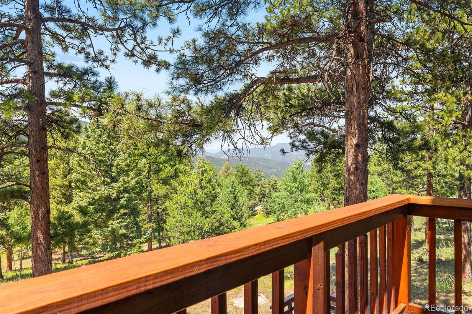 12351 South Ridge Road Conifer, CO 80433 - Photo 33 of 50 a view of a forest from a balcony