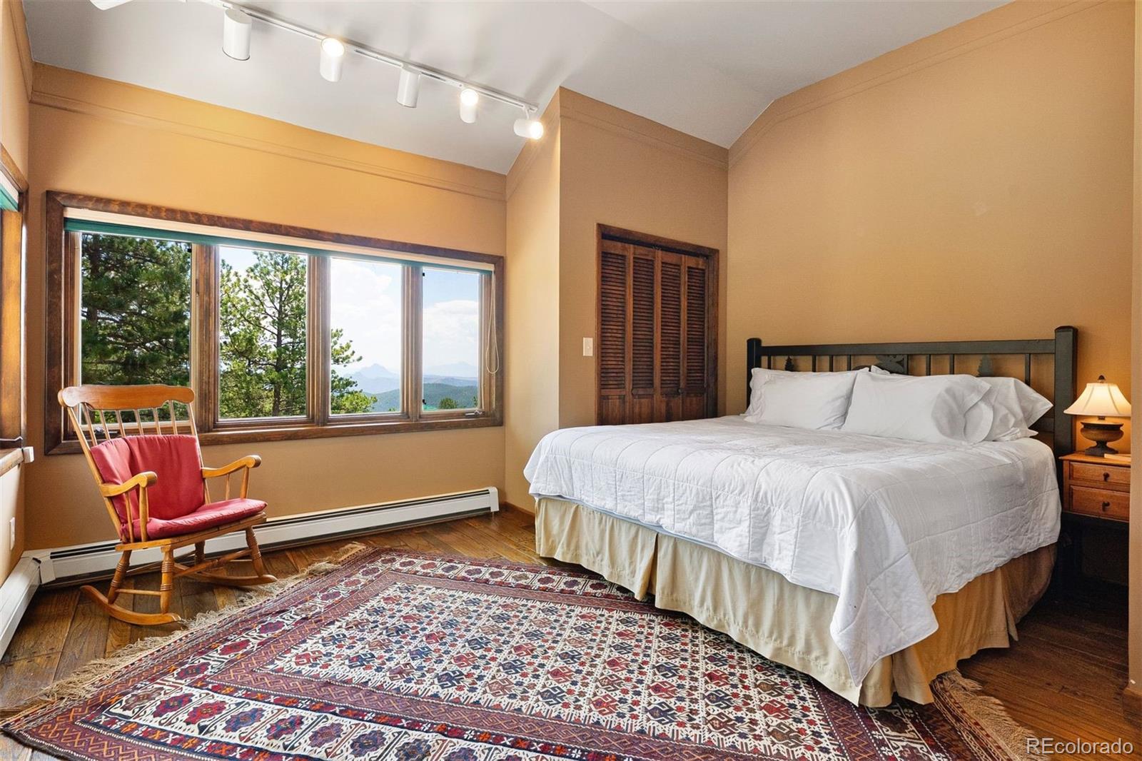 12351 South Ridge Road Conifer, CO 80433 - Photo 35 of 50 a bedroom with a bed and wooden floor