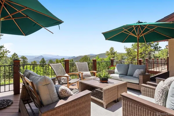 a view of a patio with a table and chairs under an umbrella