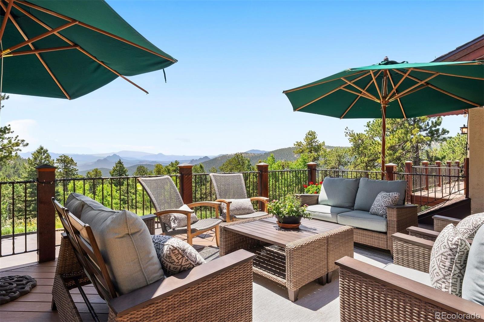 12351 South Ridge Road Conifer, CO 80433 - Photo 38 of 50 an outdoor sitting area with furniture and umbrella