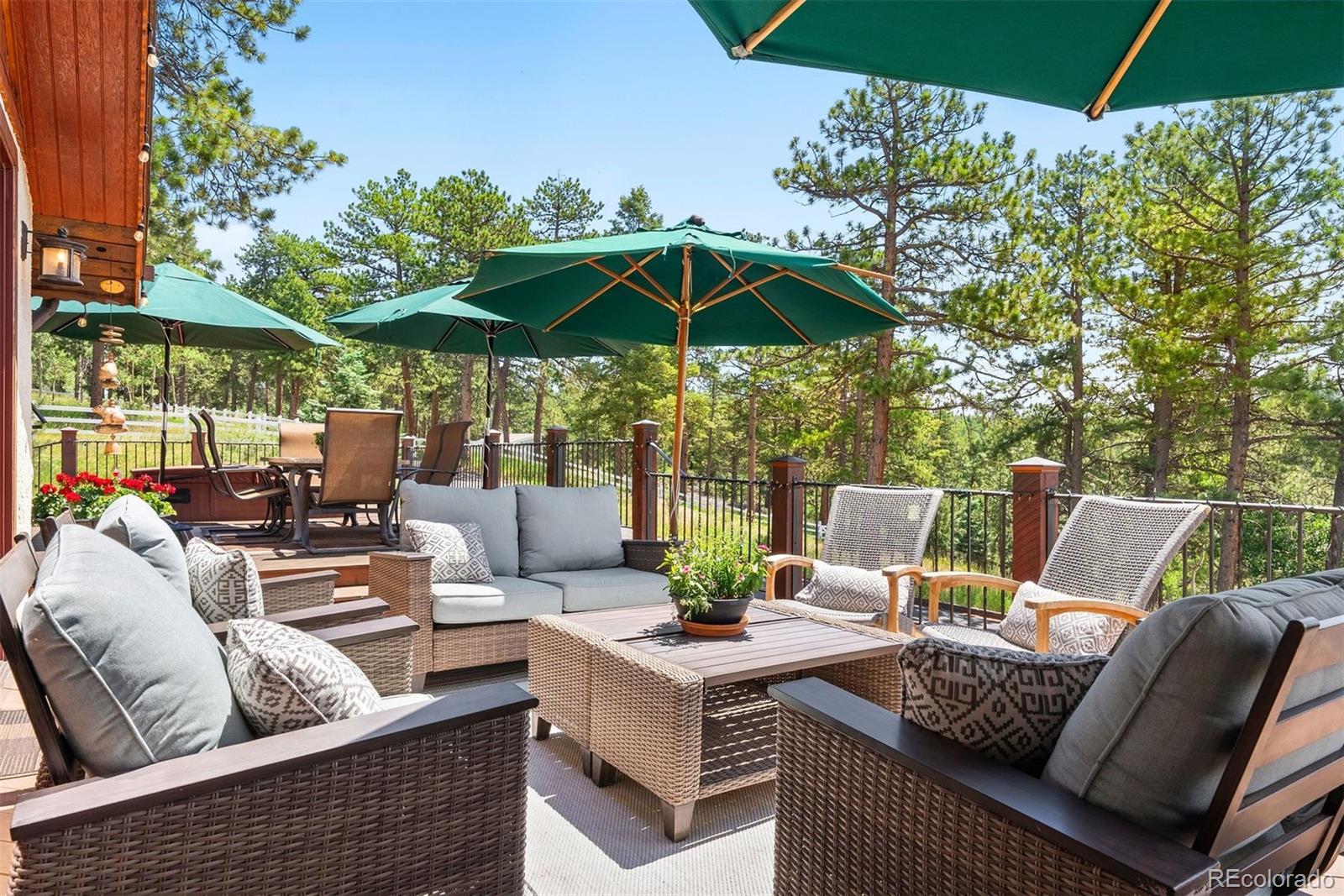 12351 South Ridge Road Conifer, CO 80433 - Photo 39 of 50 a view of a patio with a table and chairs under an umbrella