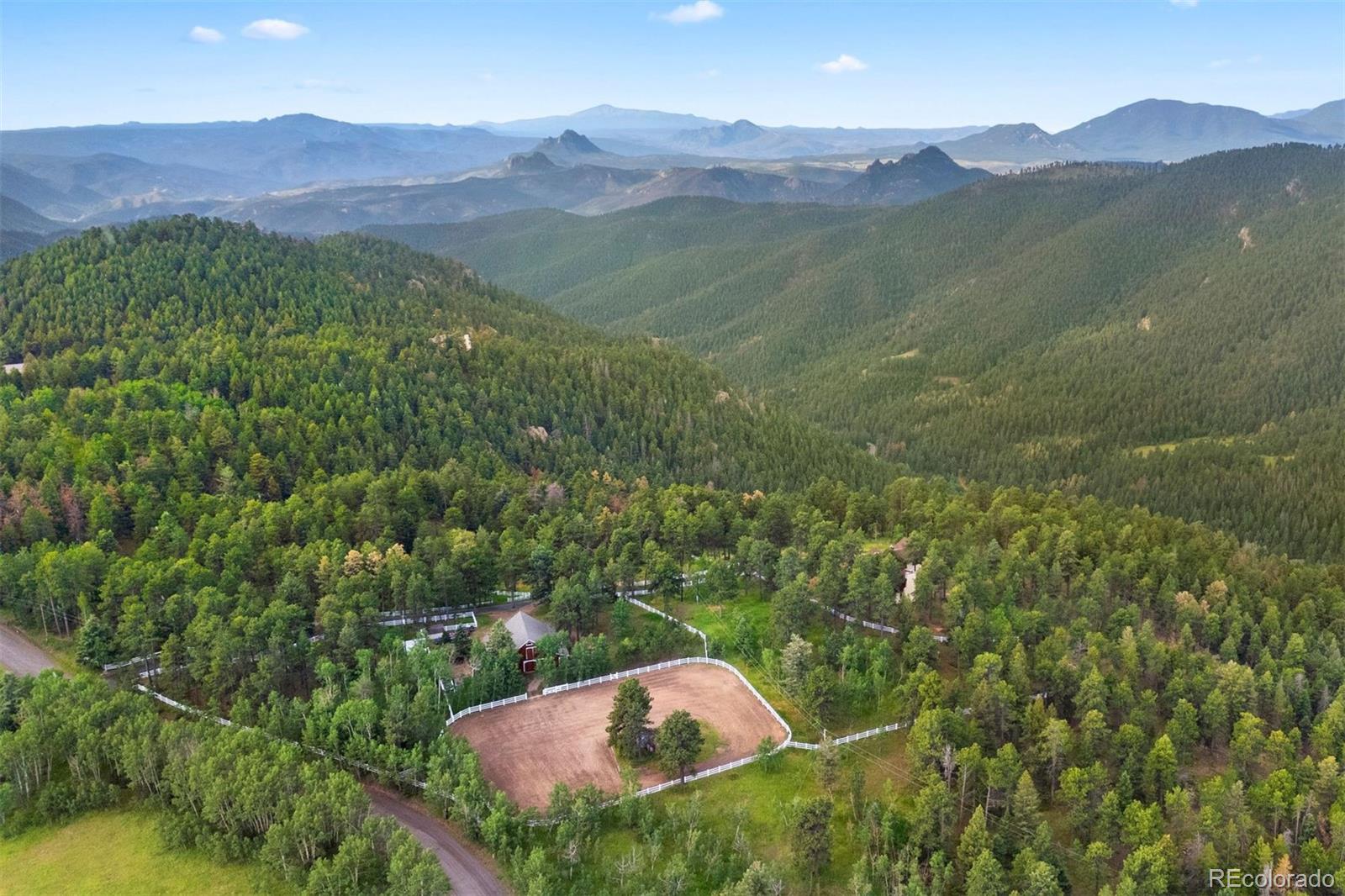 12351 South Ridge Road Conifer, CO 80433 - Photo 47 of 50 a view of a lush green hillside and a houses