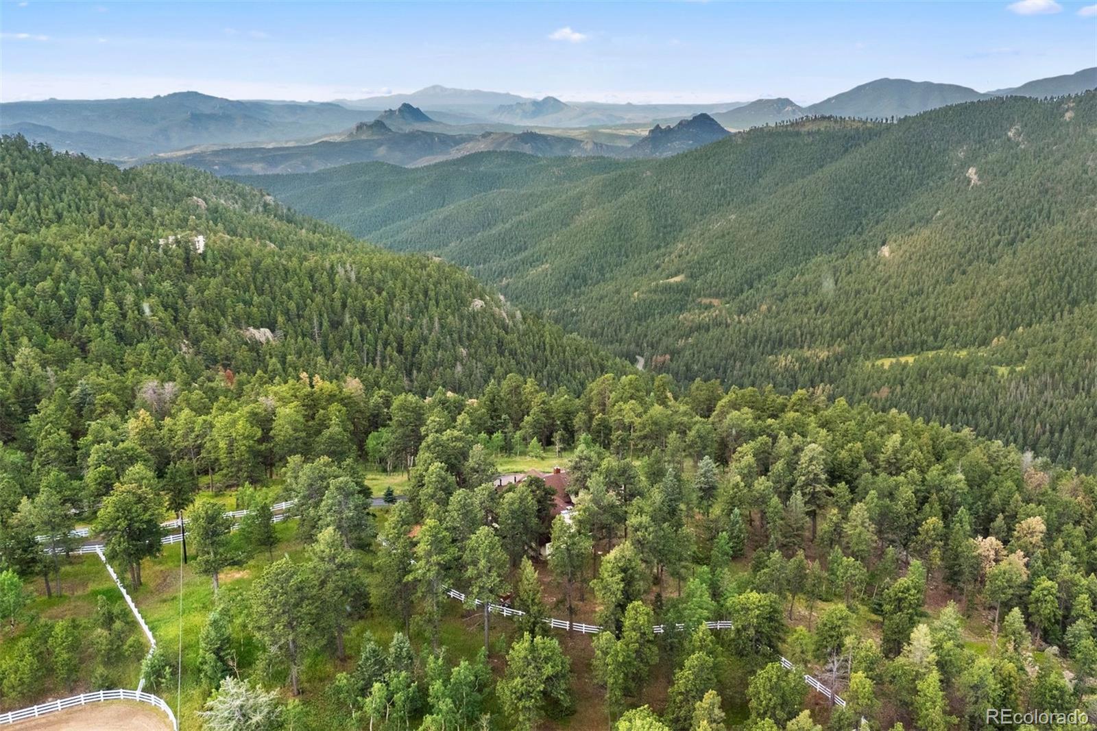 12351 South Ridge Road Conifer, CO 80433 - Photo 49 of 50 a view of a lush green hillside and a mountain