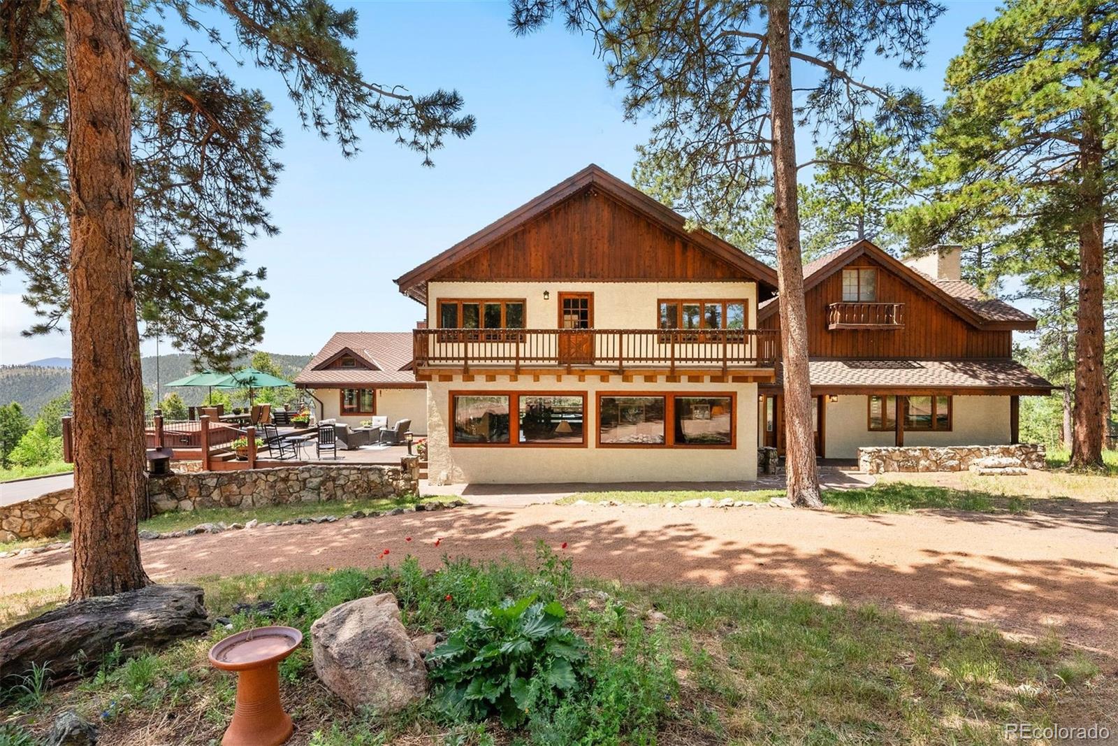 12351 South Ridge Road Conifer, CO 80433 - Photo 6 of 50 a front view of a house with a yard
